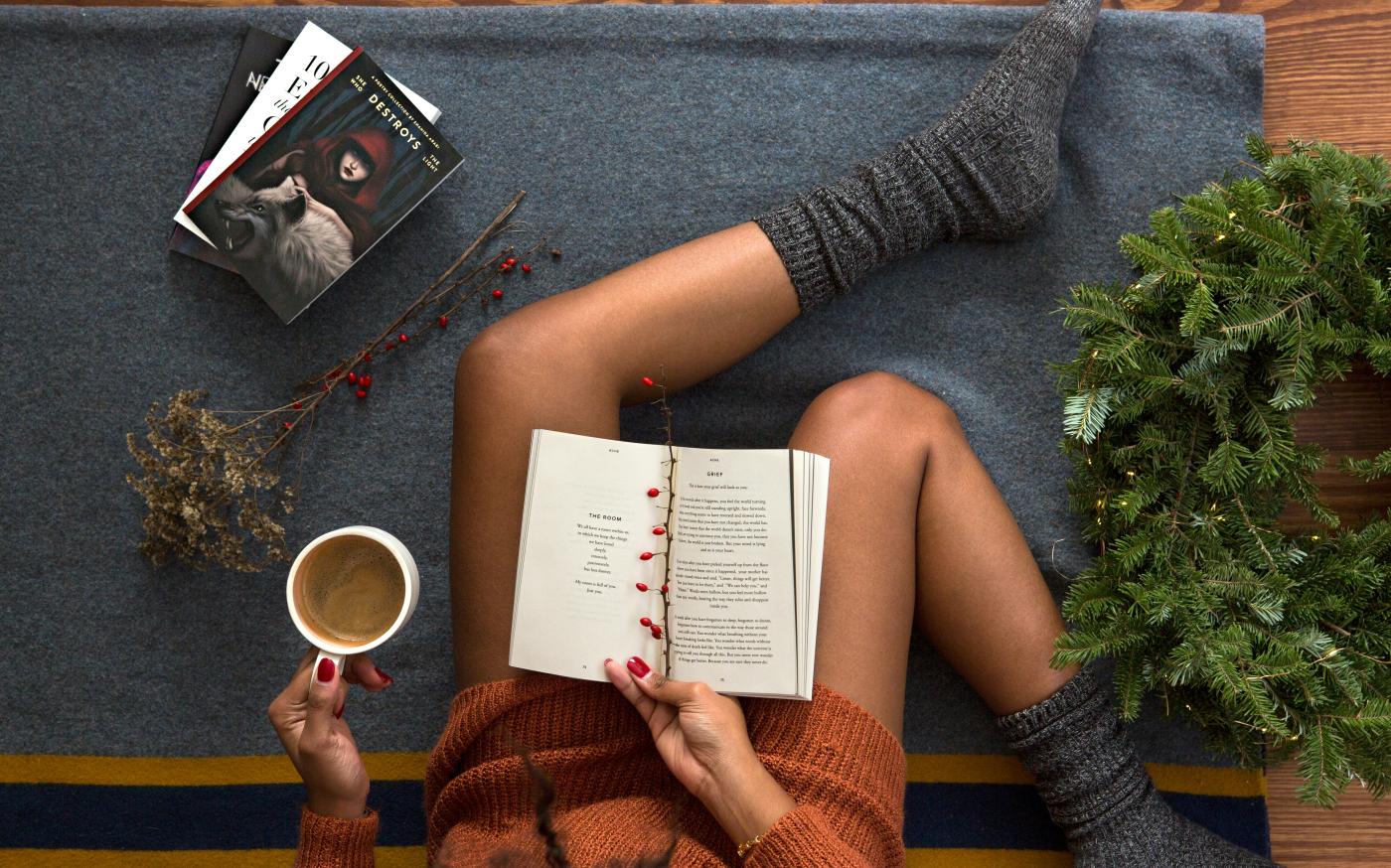 opened book on person's lap with gray socks by Thought Catalog courtesy of Unsplash.