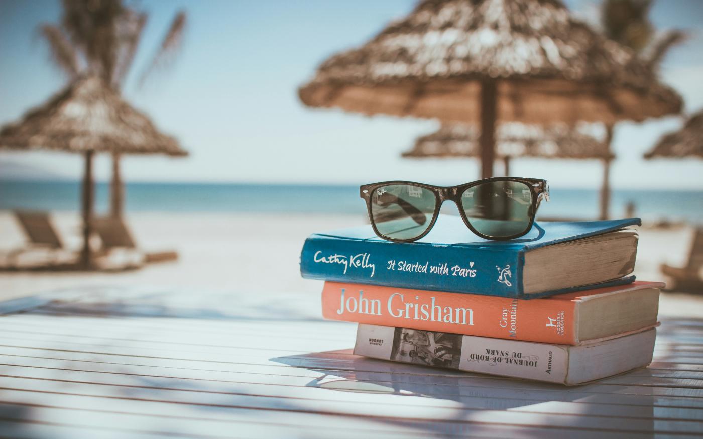 black framed Ray-Ban Wayfarer sunglasses on top of book by Link Hoang courtesy of Unsplash.