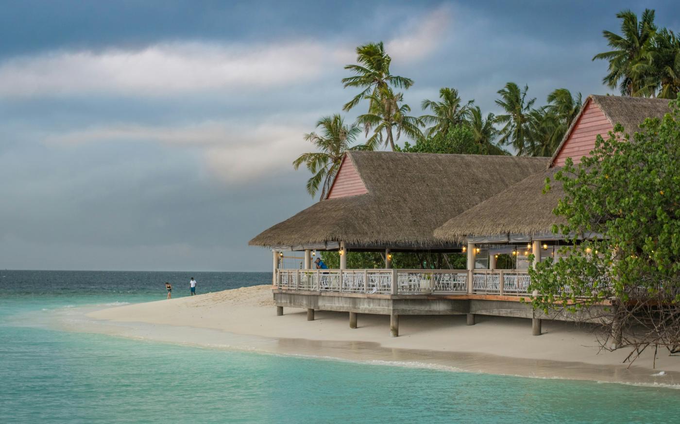 brown hut near body of water by Mohd Elle courtesy of Unsplash.