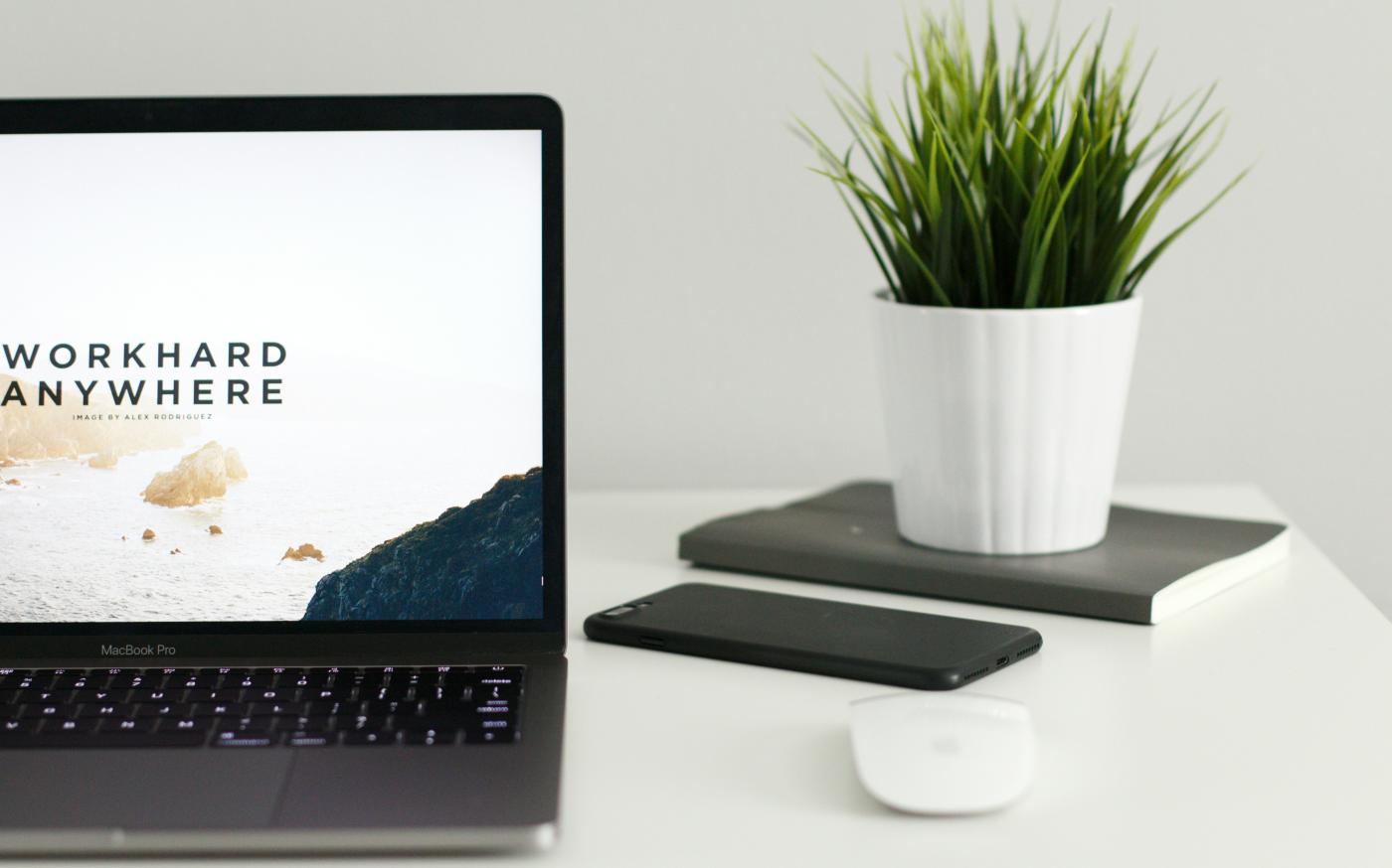 MacBook Pro near green potted plant on table by Kevin Bhagat courtesy of Unsplash.