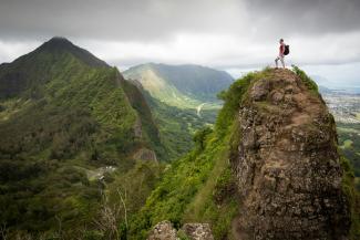 man on top of the mountain during daytime by Kalen Emsley courtesy of Unsplash.