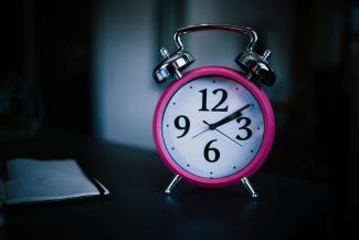 pink bell alarm clock showing 2:10 by Mpho Mojapelo courtesy of Unsplash.