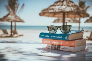 black framed Ray-Ban Wayfarer sunglasses on top of book by Link Hoang courtesy of Unsplash.