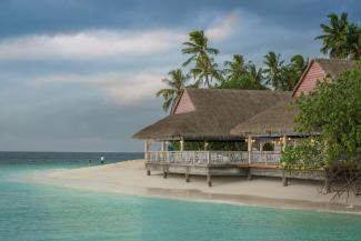 brown hut near body of water by Mohd Elle courtesy of Unsplash.