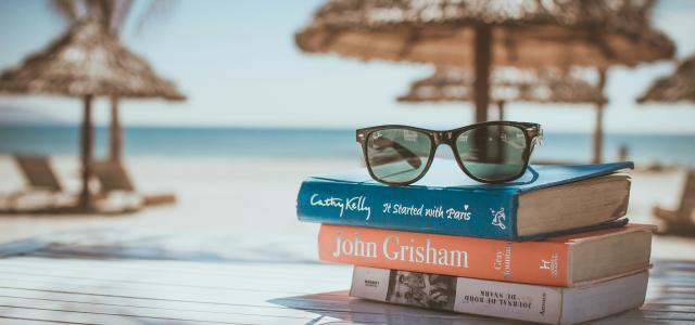 black framed Ray-Ban Wayfarer sunglasses on top of book by Link Hoang courtesy of Unsplash.