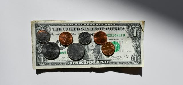 silver and gold round coins in box by Kenny Eliason courtesy of Unsplash.